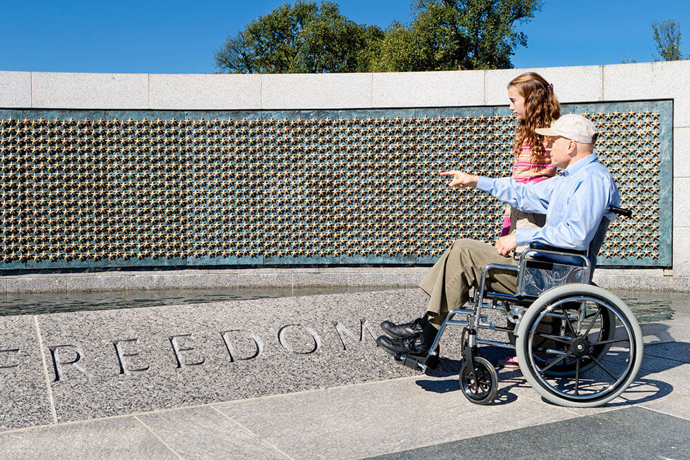 veteran with young child at monument