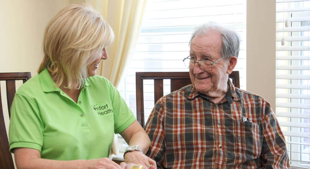 woman testing oxygen levels on older man